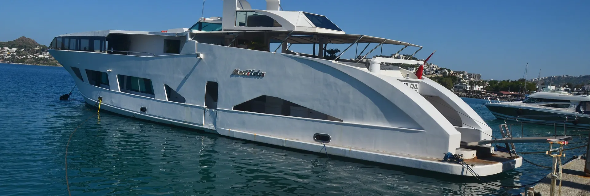A motor yacht berthed at a marina
